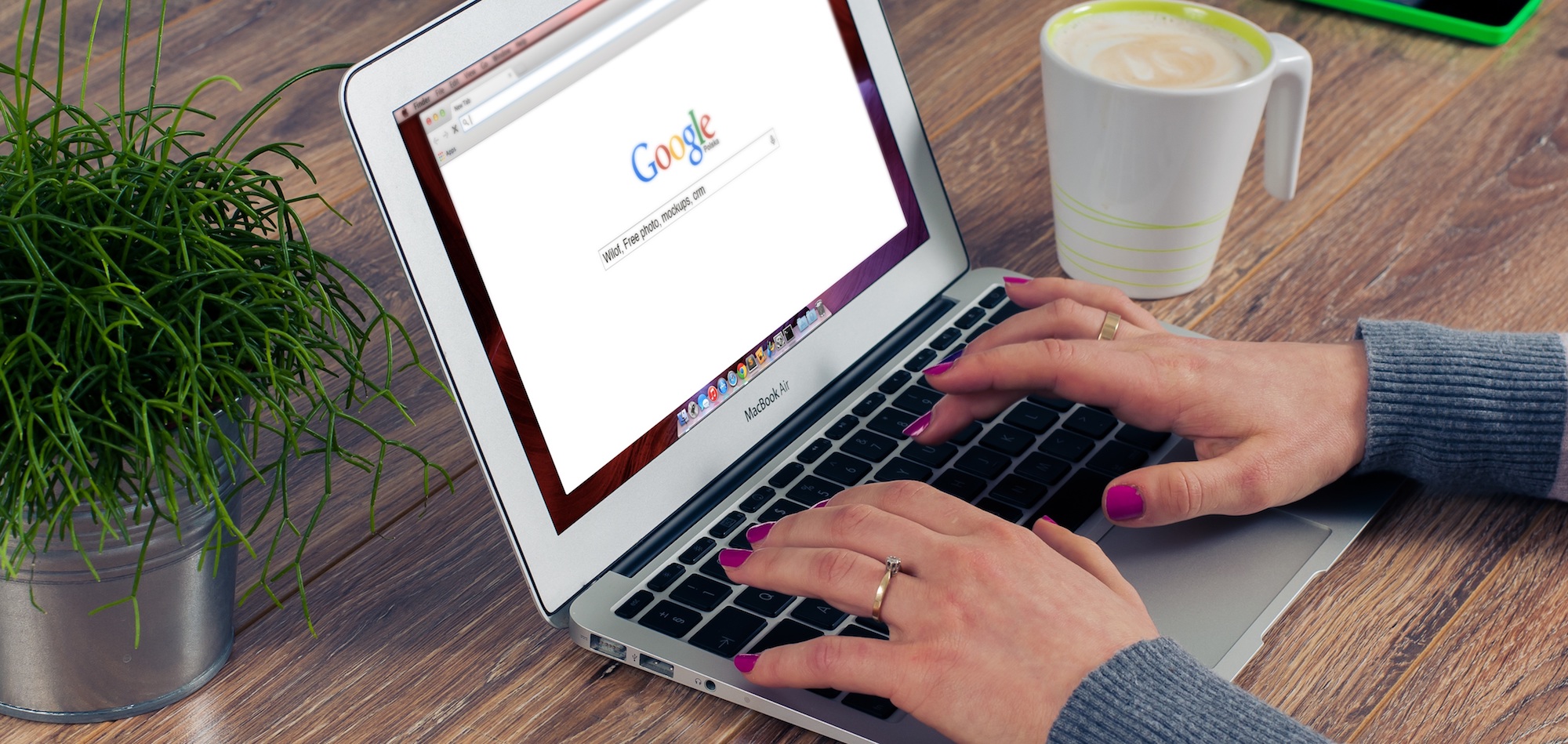 closeup of hands typing on a laptop