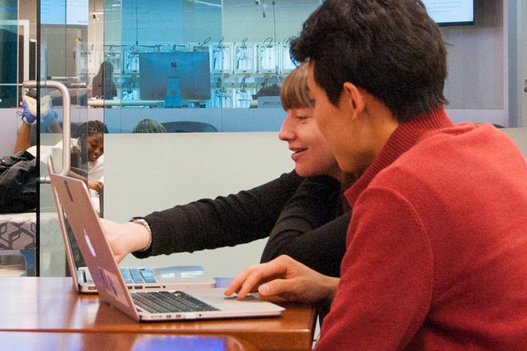 Students collaborating on their laptops in the Technology Engagement Center