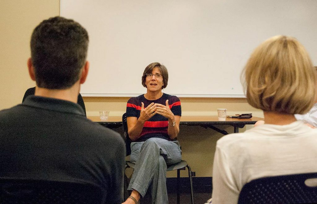 Person leading a seminar while seated