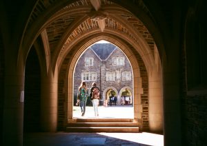 Students walking through archway on Duke campus